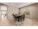 Stylish dining room featuring stacked stone accent wall and seating for six at 3044 E Trigger Way, Gilbert, AZ 85297