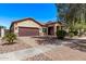 Charming single-story home featuring a two-car garage and desert landscaping at 3044 E Trigger Way, Gilbert, AZ 85297