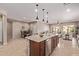 Open concept floor plan featuring a kitchen island with pendant lighting and a view of the living area at 3044 E Trigger Way, Gilbert, AZ 85297