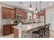 Modern kitchen island with granite countertops, pendant lighting, and stainless steel appliances at 3044 E Trigger Way, Gilbert, AZ 85297