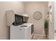 Modern laundry room with tile flooring and front-loading washing machine at 3044 E Trigger Way, Gilbert, AZ 85297