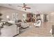 Open-concept living room flowing into kitchen with modern furnishings and tile flooring at 3044 E Trigger Way, Gilbert, AZ 85297