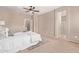 Spacious main bedroom with a ceiling fan and a view of the ensuite bathroom at 3044 E Trigger Way, Gilbert, AZ 85297