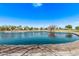 Scenic view of community pond with trees, walking paths, and beautiful landscaping at 3044 E Trigger Way, Gilbert, AZ 85297