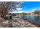 Serene view of the pond featuring a paved walking path and comfortable seating at 3044 E Trigger Way, Gilbert, AZ 85297