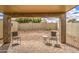 Covered back patio features a paver floor, outdoor furniture, and a rock landscape at 30718 N Coral Bean Dr, San Tan Valley, AZ 85143