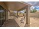 Covered patio features a paver floor, storage shed, and rock landscape at 30718 N Coral Bean Dr, San Tan Valley, AZ 85143