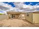 Backyard view of storage shed, rock landscaping, and covered patio with furniture at 30718 N Coral Bean Dr, San Tan Valley, AZ 85143