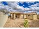 Backyard view with covered patio, storage shed, rock landscape, and block wall at 30718 N Coral Bean Dr, San Tan Valley, AZ 85143