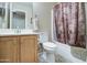 Cozy bathroom features a vanity and shower-tub combination with decorative shower curtain at 30718 N Coral Bean Dr, San Tan Valley, AZ 85143