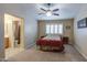 Cozy bedroom with a comfortable bed, neutral tones, and a ceiling fan at 30718 N Coral Bean Dr, San Tan Valley, AZ 85143