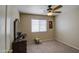 Cozy bedroom with carpet, ceiling fan, and dresser illuminated by natural light from a window at 30718 N Coral Bean Dr, San Tan Valley, AZ 85143