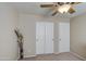 Comfortable bedroom features a ceiling fan and closet doors with carpeted floors at 30718 N Coral Bean Dr, San Tan Valley, AZ 85143