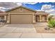 Charming single-story home featuring a two-car garage and low-maintenance desert landscaping at 30718 N Coral Bean Dr, San Tan Valley, AZ 85143