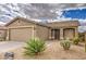 Charming single-story home showcasing desert landscaping and a two-car garage at 30718 N Coral Bean Dr, San Tan Valley, AZ 85143