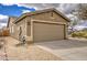 Exterior view of a two car garage and desert landscaping at 30718 N Coral Bean Dr, San Tan Valley, AZ 85143