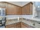 Kitchen with granite countertops, stainless steel appliances, and wooden cabinets at 30718 N Coral Bean Dr, San Tan Valley, AZ 85143