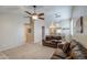 Bright living room with plush sofas, carpet, and a ceiling fan at 30718 N Coral Bean Dr, San Tan Valley, AZ 85143