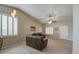 Open-concept living room showcasing neutral tones and plantation shutters at 30718 N Coral Bean Dr, San Tan Valley, AZ 85143