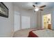 Spacious main bedroom with ceiling fan, closet, and en suite bathroom access at 30718 N Coral Bean Dr, San Tan Valley, AZ 85143