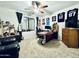 Well-lit bedroom with a ceiling fan, a desk and displays of sports memorabilia at 41 S Honeysuckle Ln, Gilbert, AZ 85296