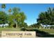 Scenic view of Freestone Park featuring lush green trees against a clear blue sky, promising a serene outdoor experience at 41 S Honeysuckle Ln, Gilbert, AZ 85296