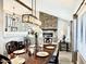 Elegant dining room featuring a stone fireplace, modern lighting and staircase at 41 S Honeysuckle Ln, Gilbert, AZ 85296