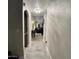 Hallway view leading into a naturally lit home with a kitchen, dining area, and living room at 41 S Honeysuckle Ln, Gilbert, AZ 85296