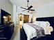 Comfortable main bedroom featuring a ceiling fan, wooden sliding barn door, and modern furnishings at 41 S Honeysuckle Ln, Gilbert, AZ 85296