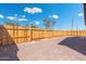 A newly installed wooden fence enhances privacy and defines the property line in the spacious backyard at 410 S 98Th Pl, Mesa, AZ 85208