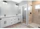 Modern bathroom featuring double sinks, sleek white cabinetry, and a tiled walk-in shower at 410 S 98Th Pl, Mesa, AZ 85208