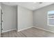 A modern bedroom with light gray walls and wood-look floors provides a serene and stylish space at 410 S 98Th Pl, Mesa, AZ 85208