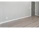 A bedroom showcases light gray walls and wood-look floors providing a calming atmosphere at 410 S 98Th Pl, Mesa, AZ 85208