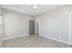 Minimalist bedroom with light gray walls, light wood floors, and a serene atmosphere at 410 S 98Th Pl, Mesa, AZ 85208