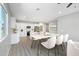 Well-lit dining area with modern table set, flowing seamlessly into the contemporary kitchen at 410 S 98Th Pl, Mesa, AZ 85208