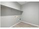 Spacious laundry room with floating shelves offering ample storage, enhanced by sleek, modern design at 410 S 98Th Pl, Mesa, AZ 85208