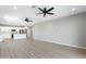 A spacious living room open to the kitchen features modern flooring and neutral walls at 410 S 98Th Pl, Mesa, AZ 85208