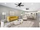 Stylish living space with sofa and chairs opening to a bright kitchen and dining area at 410 S 98Th Pl, Mesa, AZ 85208