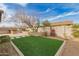 View of backyard with artificial turf, planters and built-in outdoor kitchen at 412 W Lyle Ave, San Tan Valley, AZ 85140