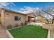 Spacious backyard with manicured grass, outdoor kitchen, and covered patio at 412 W Lyle Ave, San Tan Valley, AZ 85140