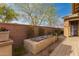 Beautiful backyard landscape with brick wall, water feature, and stone pavers at 412 W Lyle Ave, San Tan Valley, AZ 85140