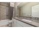 Bathroom with dual sinks and a shower-tub combo featuring decorative black and white tiling at 412 W Lyle Ave, San Tan Valley, AZ 85140