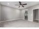 Neutral bedroom has plush carpeting and access to the ensuite bathroom with glass shower at 412 W Lyle Ave, San Tan Valley, AZ 85140