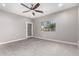 Spacious bedroom features a ceiling fan, plush carpet, and natural light from a large window at 412 W Lyle Ave, San Tan Valley, AZ 85140