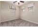 Inviting bedroom featuring a ceiling fan, neutral paint, carpet and bright windows with elegant roman shades at 412 W Lyle Ave, San Tan Valley, AZ 85140