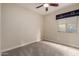 Carpeted bedroom has a ceiling fan and a window with pleated blinds at 412 W Lyle Ave, San Tan Valley, AZ 85140