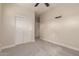 Neutral bedroom with carpet, ceiling fan, closet, and a shelf, providing a comfortable living space at 412 W Lyle Ave, San Tan Valley, AZ 85140