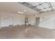 Spacious garage with epoxy flooring, doors, and ample room for parking and storage at 412 W Lyle Ave, San Tan Valley, AZ 85140