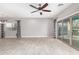 Bright living room with tile flooring, a ceiling fan, and large windows offering plenty of natural light at 412 W Lyle Ave, San Tan Valley, AZ 85140