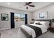 Comfortable main bedroom featuring a ceiling fan, large window, neutral decor and carpeted floor at 412 W Lyle Ave, San Tan Valley, AZ 85140